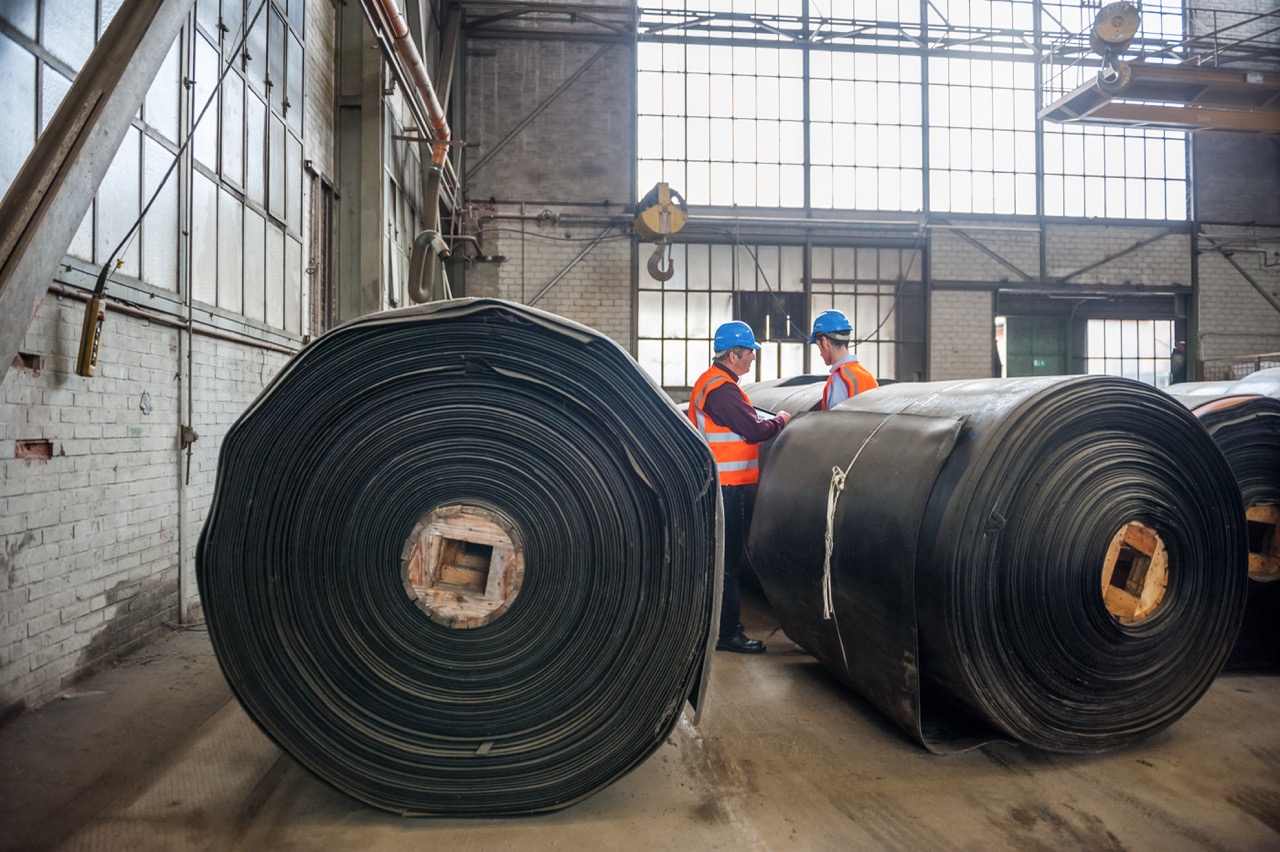 Rolls of industrial conveyor belting in warehouse